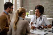 man and woman seeing a fertility specialist