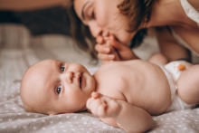 mom kisses baby's foot