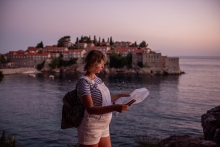 pregnant woman traveling reads map