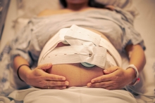 pregnant woman in hospital gown and monitors