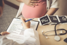 doctor consults with pregnant woman