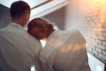 young woman rests head on partner's shoulder