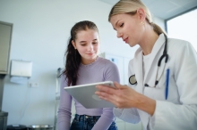 teenage girl meets with female doctor 