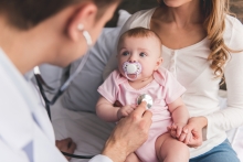 doctor listens to baby's heart