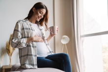 pregnant woman holds belly