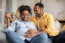 man feels baby kicking in pregnant belly