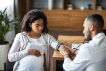 pregnant woman in blood pressure cuff