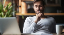 man at computer taking in information