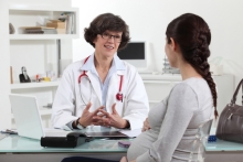 doctor meets with pregnant patient