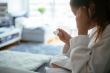 woman checking home pregnancy test